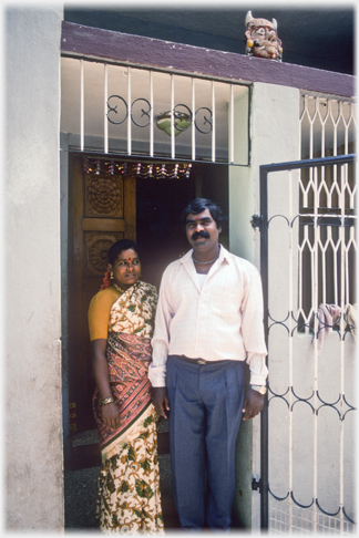 Couple at door of house.
