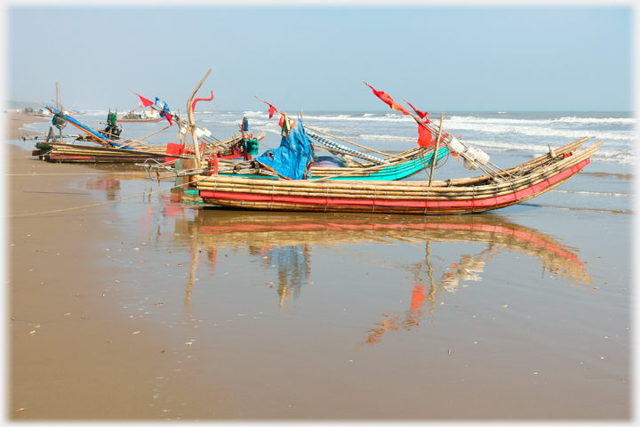 Coloured boats on beach at Tinh Gia