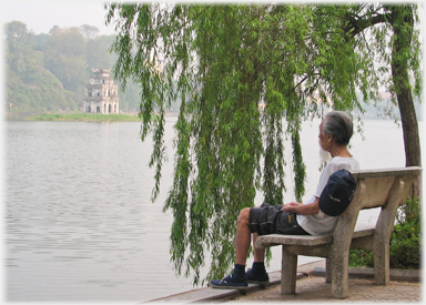 Older man sitting by the Lake
