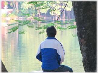 Boy sitting by the Lake