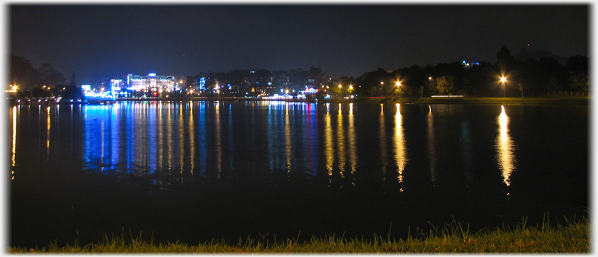 Night view with lights reflected in the lake.