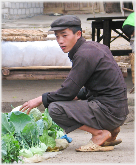 Man buying cabbages.