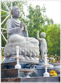 The Buddha and child at the head of the open air square with the other statues.