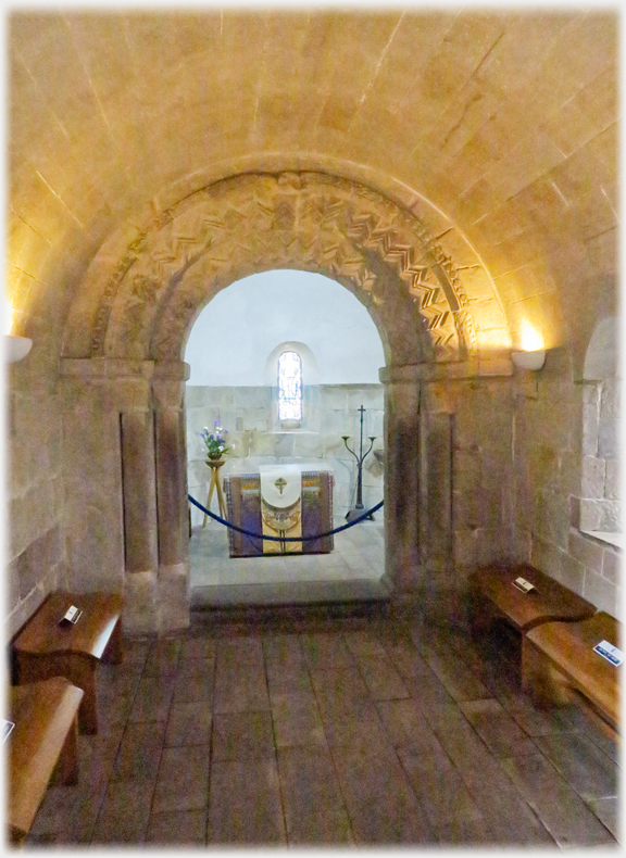 Interior with curved Norman arch of the chapel.