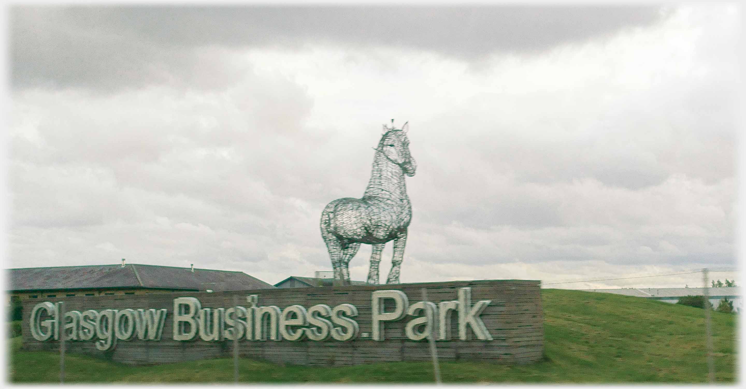 Large wire horse and sign 'Glasgow Business Park'.