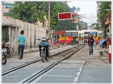 Unprotected railway line with motorbike parked between rails.
