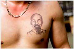 Man's chest with tattoo of Ho Chi Minh's head on his left breast.