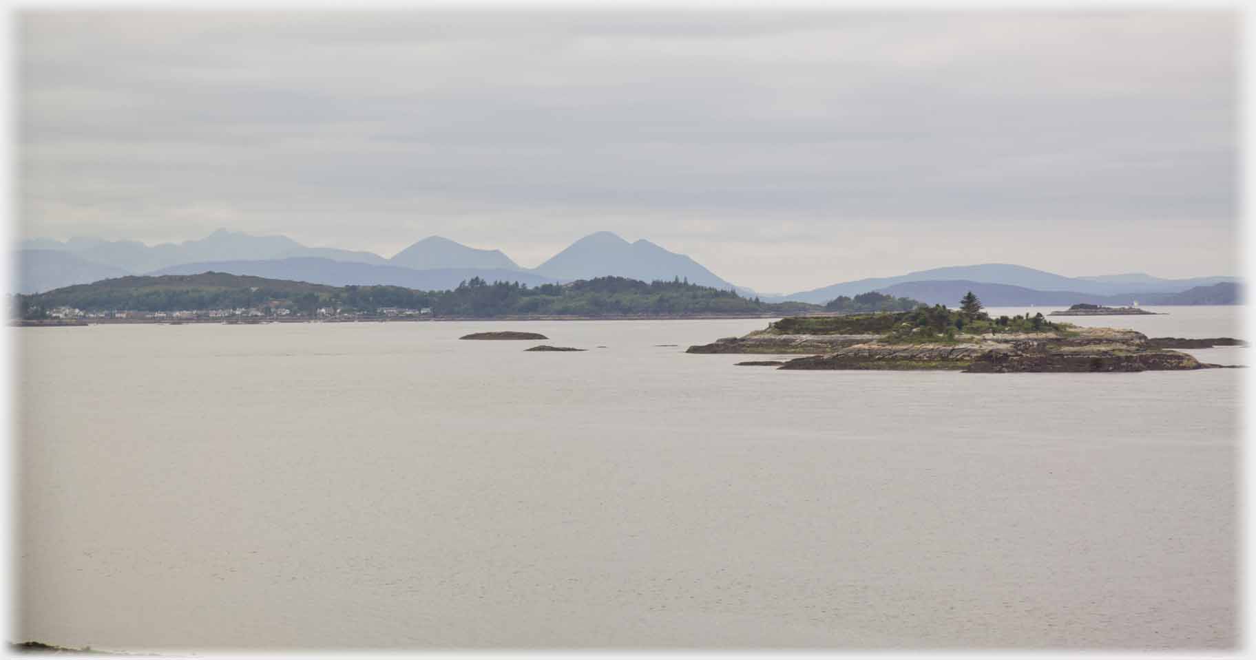 The Skye hills in the distance islets in the foreground.
