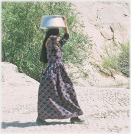 Woman with vessel on her head.