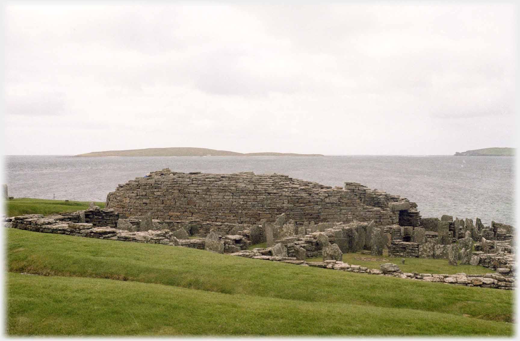 Ruins with sea and islet beyond.