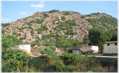 Rocky hill by village.
