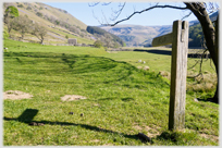 Grassed valley floor with signpost.