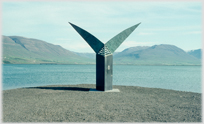 Large 'Fishtail' scupture with water and hills behind.