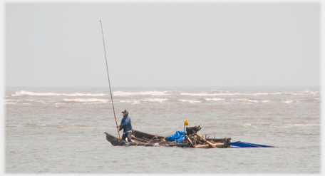 Blue fisherman on flat boat