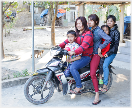 Three women and two children on a motorbike.