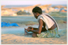 A fisherman mending his net on Madras beach.