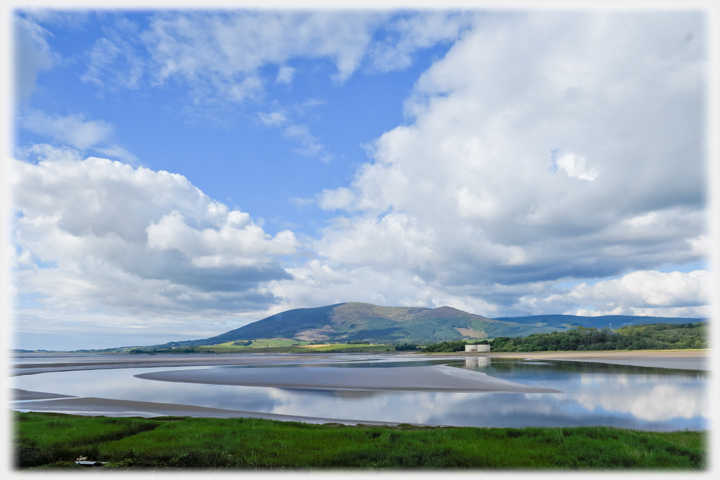 View of hill across bay with clouds.