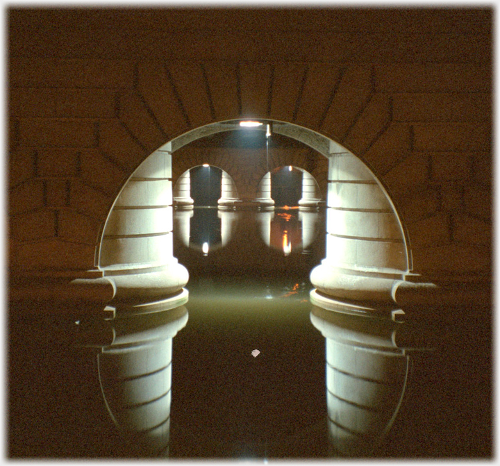 Arches and pillars below bridge.