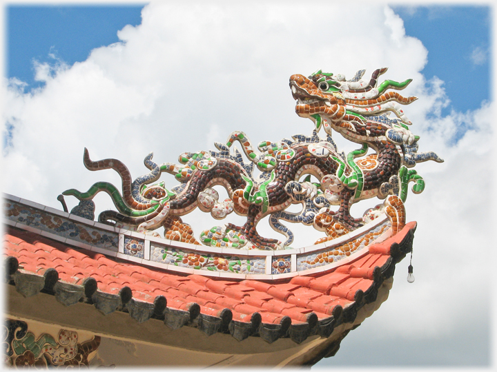 Tiled dragon on roof top.