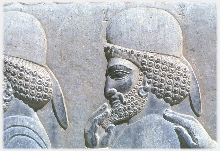 Bas-relief head of man stroking his beard.