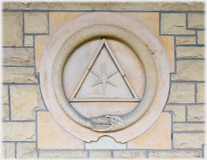 Two men beside meat stall.