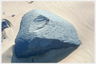 A boulder on a beach.