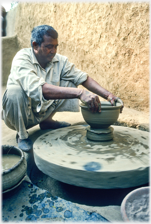 Potter turning pot.