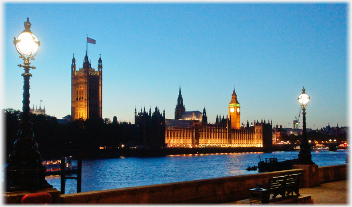 houses of Parliament in London looking across the Thames.