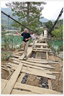 Two people walking on disintegrating bridge.