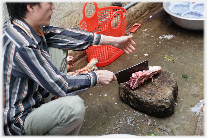Ox bones being cut up with a cleaver.