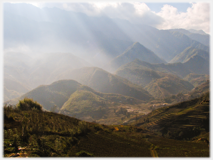 Looking out across the mountains from Sa Pa with shafts of light falling through the clouds.