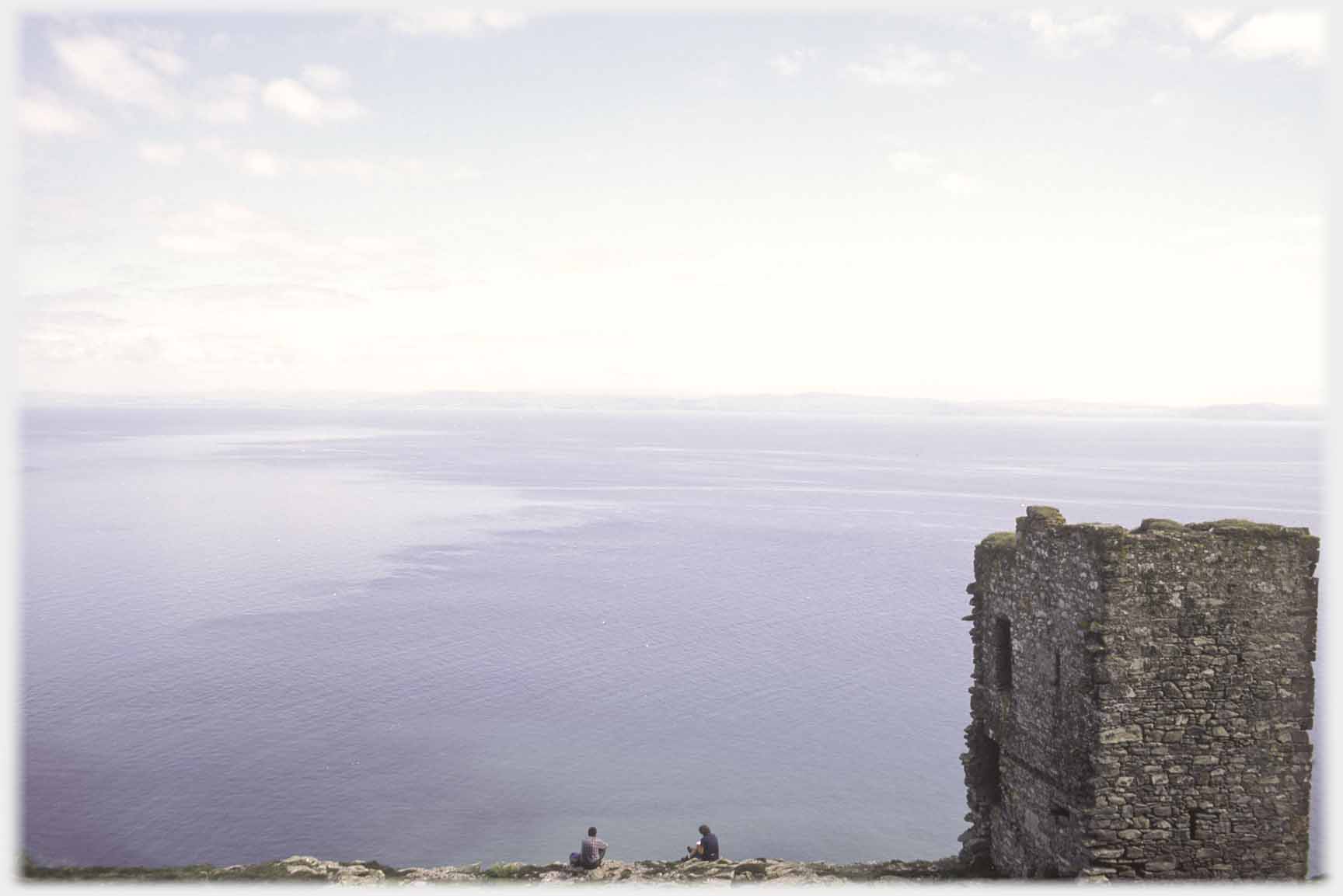 Another angle of tower house with two people sitting.