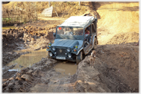 Jeep in deep mud ruts.