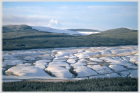 Complex snow covered surfaces of hillside.