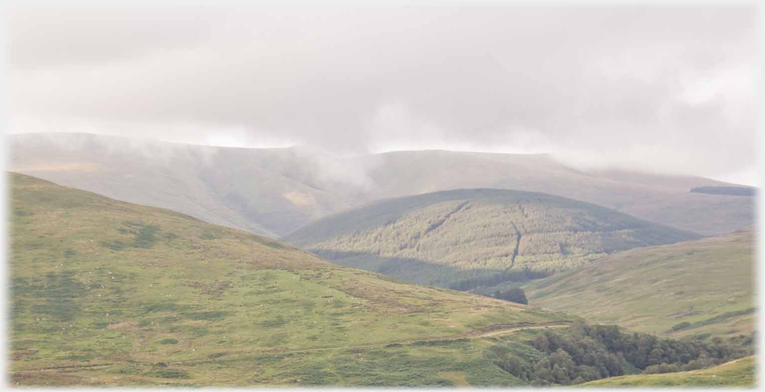 The hills with clouds interrupting the skyline.