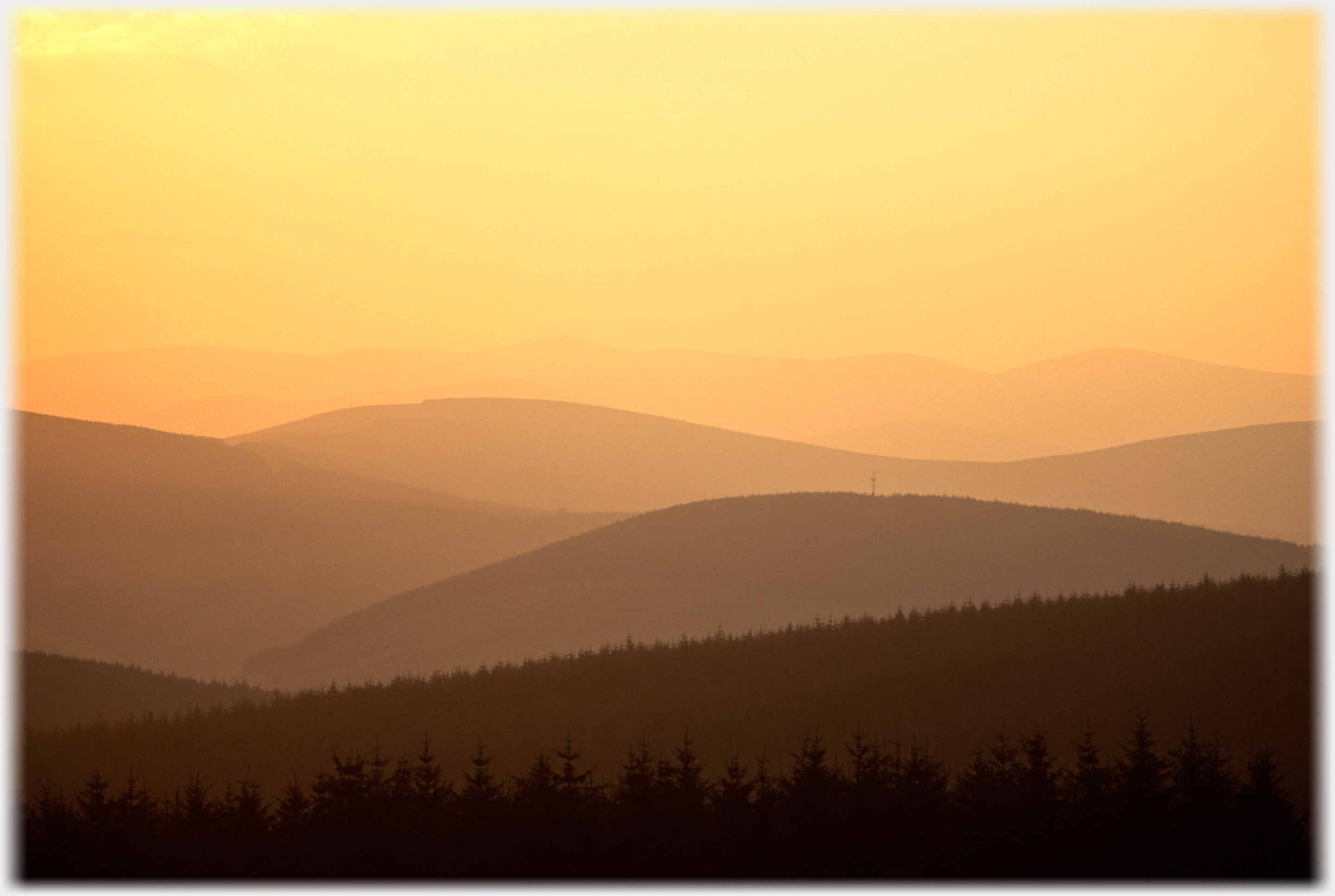 Hills receeding in golden light.