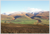 Range of hills capped with snow.
