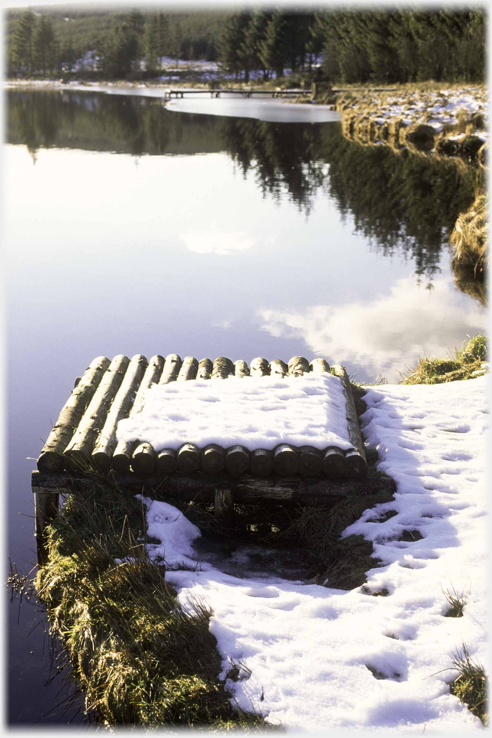 Small slatted stage at water's edge.