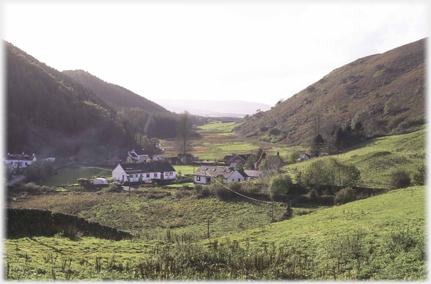 Valley with hamlet at near end.