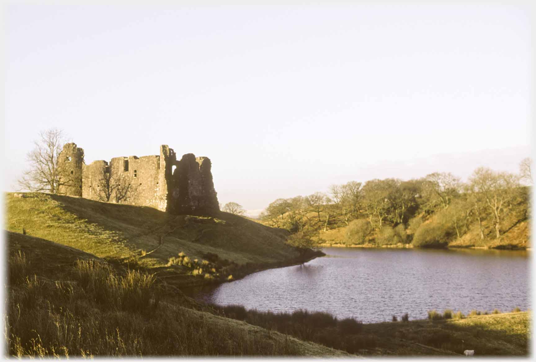 Castle on small bluff above lake.
