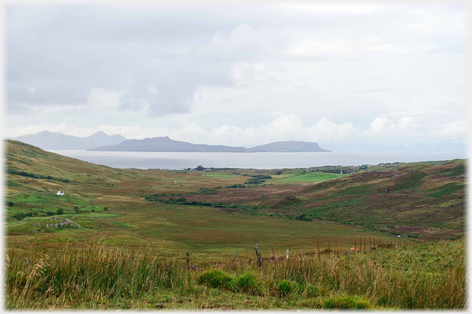 Wide valley opening to sea with islands beyond.