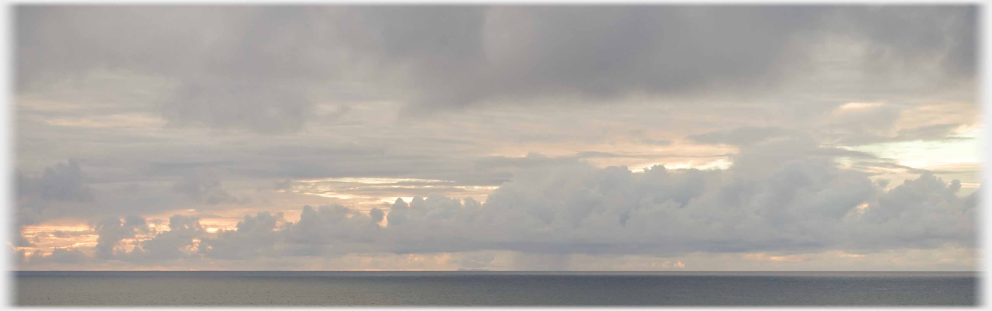 Long band of rugged clouds.