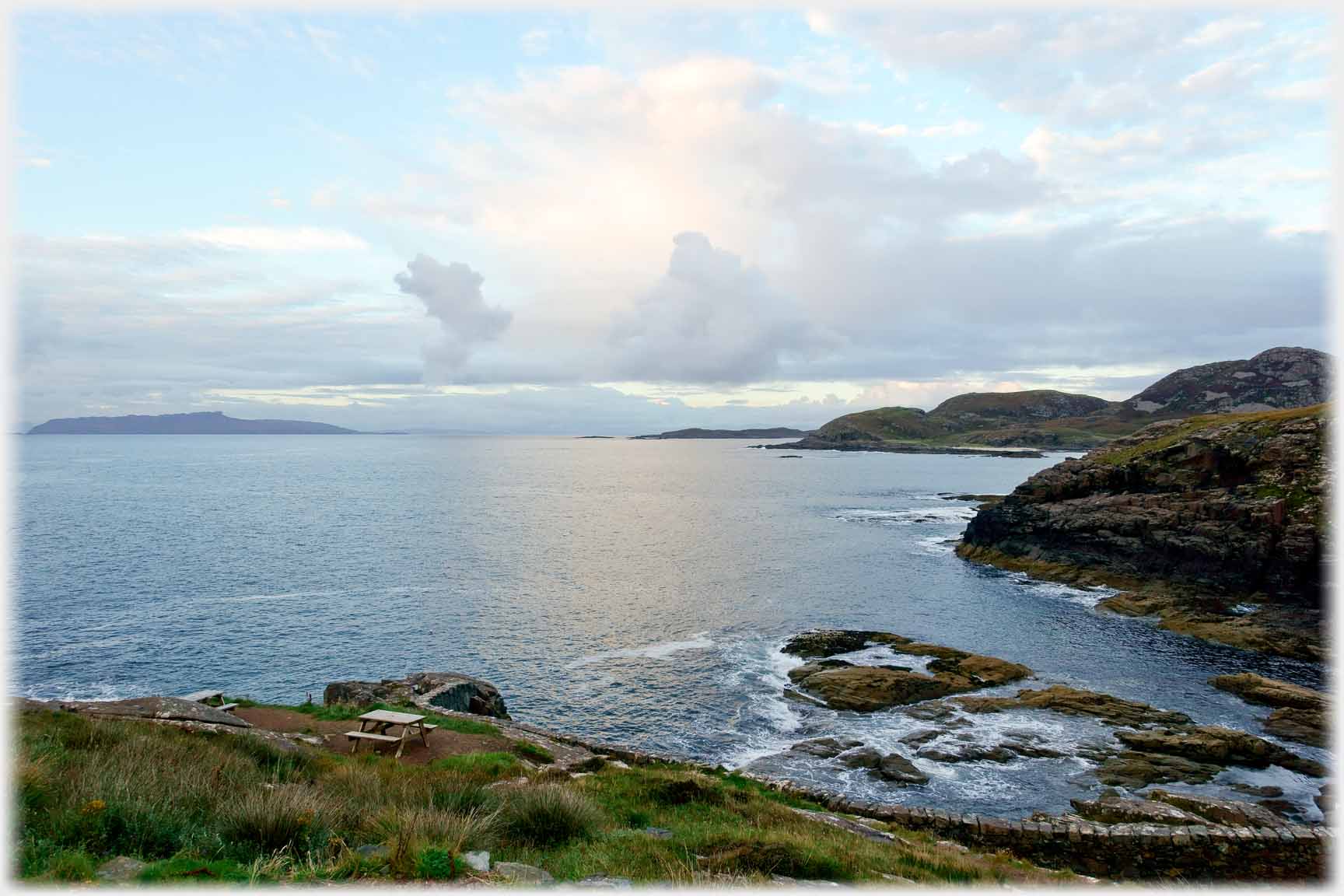 Bay with clouds over island.