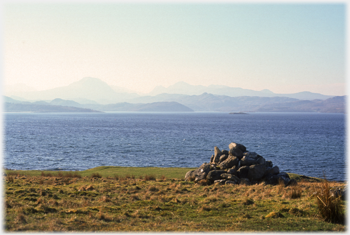 Cairn in foreground, loch and hills beyond.