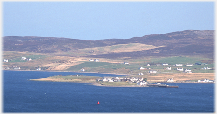 Low promontory with houses on it.