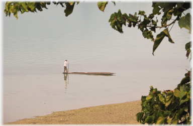 Man allowing his boat to float to the shore.