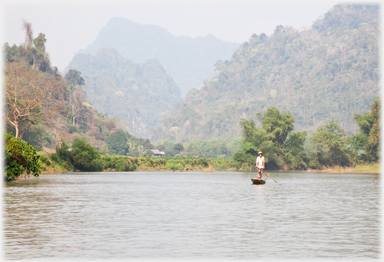 Boat in context of local hills and river.