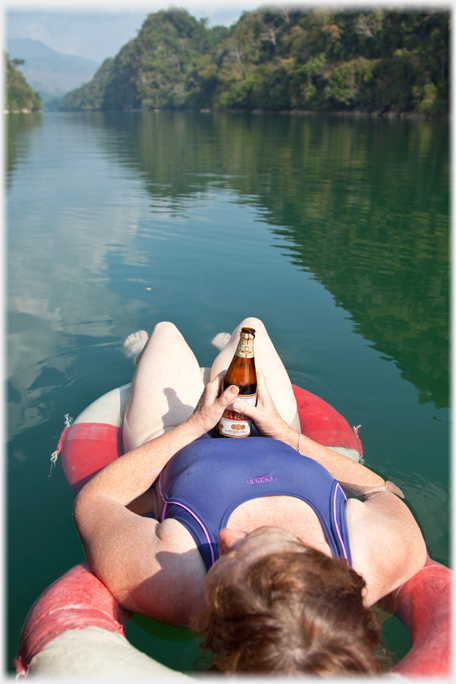 Barbara relaxing with a beer on the lake.