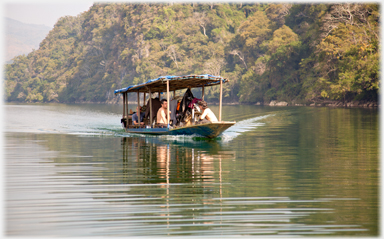 Launch with tourists heading up lake.