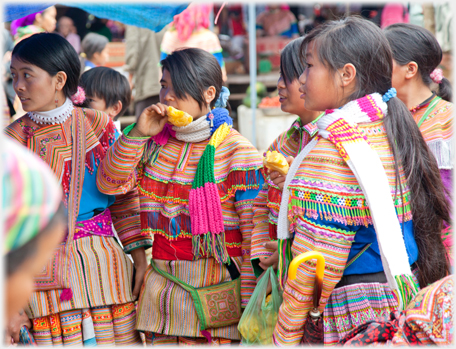 Girls eating pineapple.